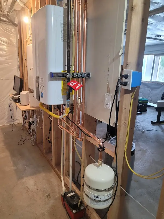 Licensed plumber repairing a kitchen sink in Roland
